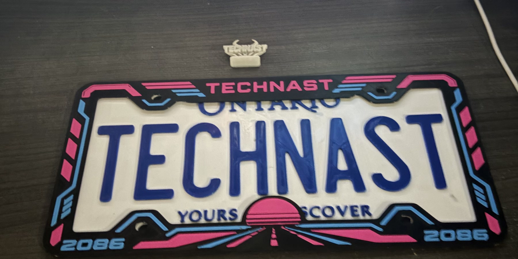Real photo of the Neon Horizon frame in Neon Pink and Blue.