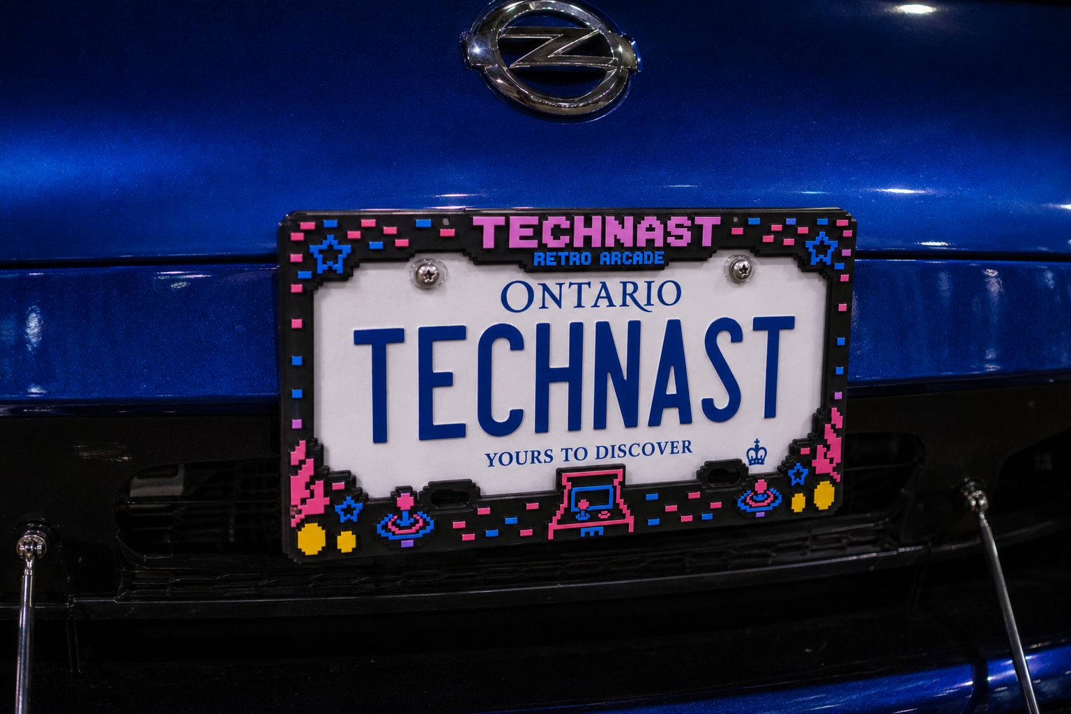 TECHNAST Retro Arcade license plate frame fitted to a blue custom car.